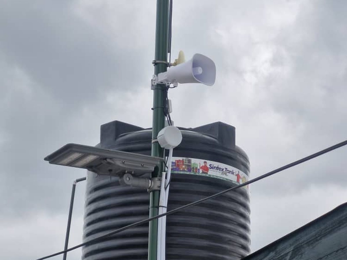 An instrumented site: tank, camera and solar lighting on one mast